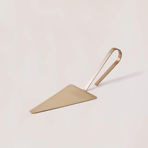 Loop cake server with rounded brass-toned handle, front view