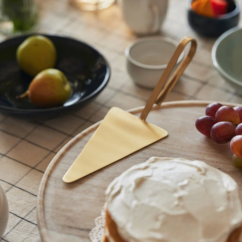 Loop cake server with rounded brass-toned handle, alternate angle